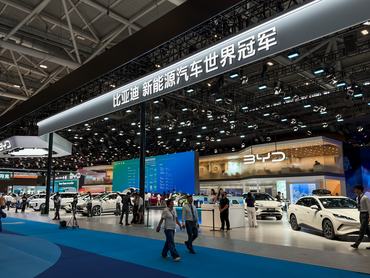 SHENZHEN, CHINA - JUNE 3: Visitors walk past the BYD booth during the 30th Guangdong-Hong Kong-Macao Greater Bay Area Auto Show on June 3, 2026, in Shenzhen, Guangdong Province, China. A banner above the booth reads World Champion of New Energy Vehicles, highlighting BYD's position as one of the world's leading new energy vehicle manufacturers. (Photo by Cheng Xin/Getty Images)