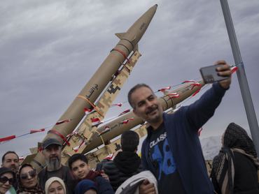 An Iranian family takes a selfie with Iran-made ballistic missiles displayed during a rally commemorating the 47th anniversary of the Islamic Revolution's victory in Azadi (Freedom) Square in western Tehran, Iran, on February 11, 2026. (Photo by Morteza Nikoubazl/NurPhoto via Getty Images)
