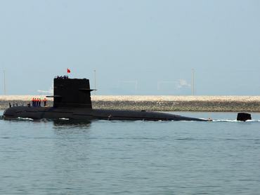QINGDAO, CHINA - APRIL 22: A Chinese navy submarine leaves Qingdao Port on April 22, 2009 in Qingdao of Shandong Province, China. China's navy is set to hold a huge maritime ceremony to mark its 60 years of the Chinese navy and has invited ships and top officials from dozens of countries to attend. (Photo by Guang Niu/Pool/Getty Images)