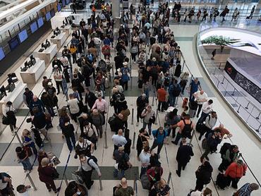 HOUSTON, TEXAS - MARCH 19: Travelers wait in line at Terminal E at George Bush International Airport on March 19, 2026 in Houston, Texas. Airports across the country continue to experience long lines during the federal shutdown affecting TSA. (Photo by Antranik Tavitian/Getty Images)